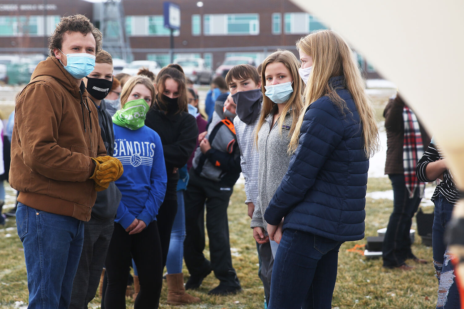 Dane Christoffersen, left, talks with the middle schoolers about the thickness of the balloon